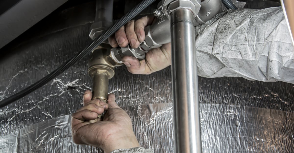 Water heater repair technician replacing heating element